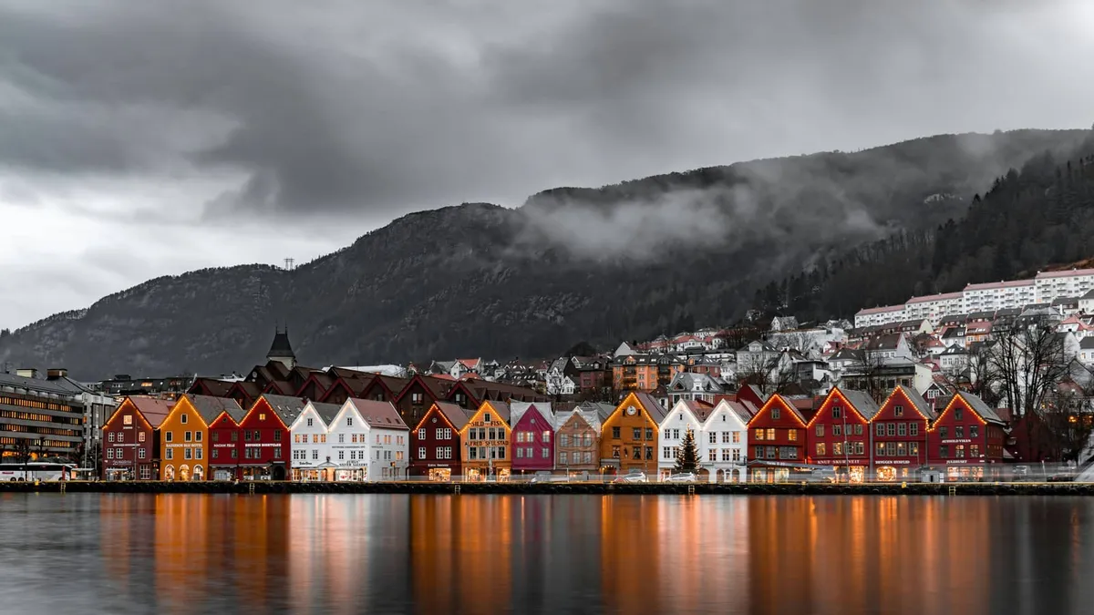 The historic wooden wharf houses of Bryggen in Bergen, lit up at dusk